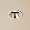 polished  chrome downlight mounted on the ceiling in a modern home