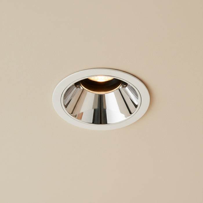 polished  chrome downlight mounted on the ceiling in a modern home