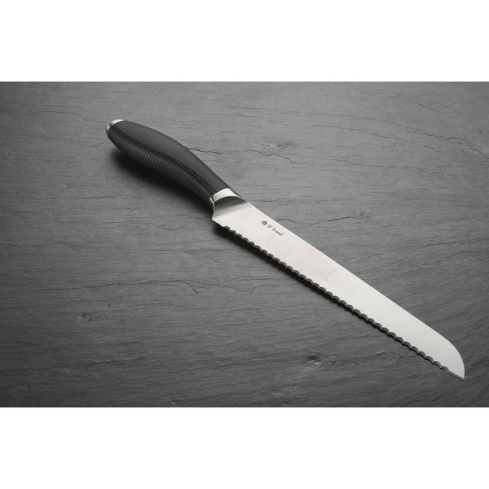 Image shows the serrated bread knife with Japanese steel blade on a grey background.
