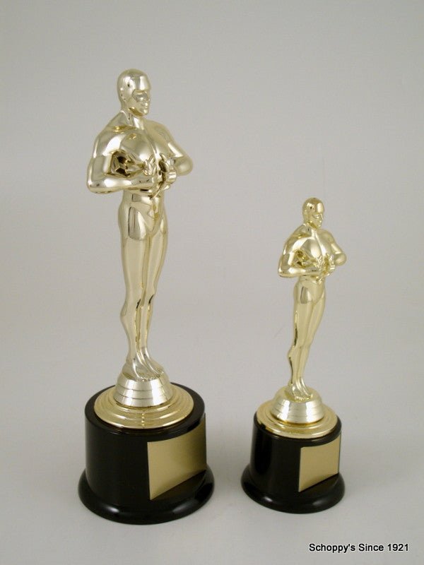 Two gold-tone Achievement figurine trophies on black bases with blank gold nameplates, arranged by size on a light gray background.