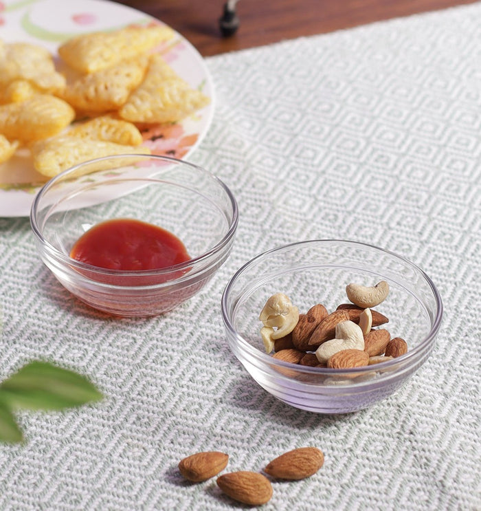 Glass bowl filled with ketchup and dry fruits ready for serving.