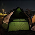 Gopamir G450 air shelter glowing with interior light at night, body TPU door area covered by green panels