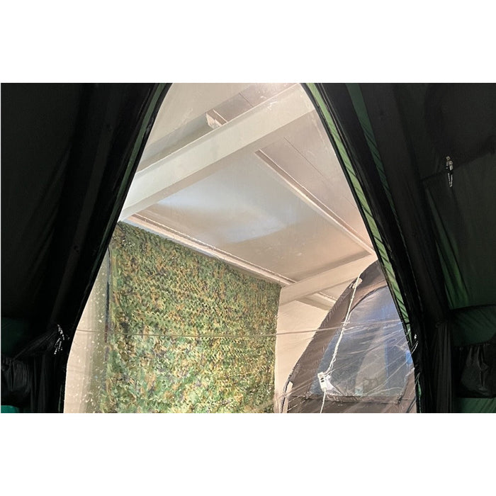 View out through the open Gopamir G450 body TPU door frame from inside, camouflage netting and awning beyond