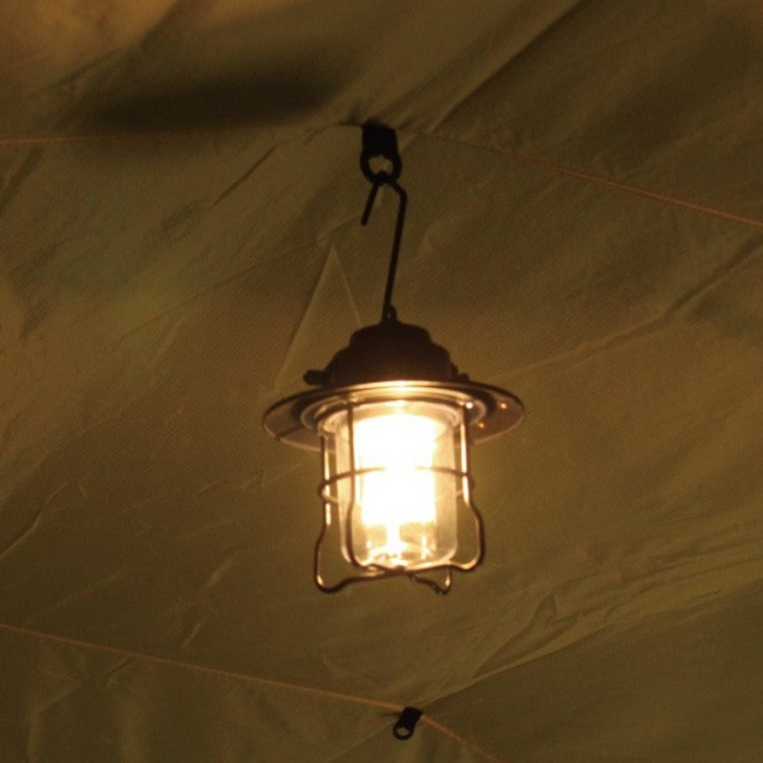Vintage lantern hanging from a black hook on the Gopamir T720+ Inner Liner, casting warm light inside the tent