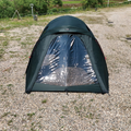 Front view of a dark green Gopamir TN600 shelter with the clear TPU window panel zipped into the door