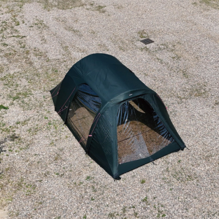 Aerial view of forest-green Gopamir TN600 TPU tent with clear window panels installed, pitched on a gravel campsite