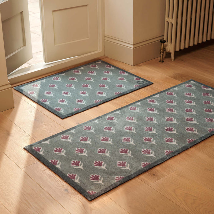 Ditsy Floral Green- 100% recycled cotton doormat featuring a woodblock pattern of purple flowers.