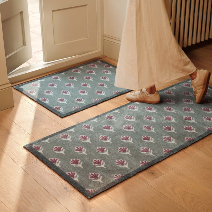 Ditsy Floral Green- 100% recycled cotton doormat featuring a woodblock pattern of purple flowers.
