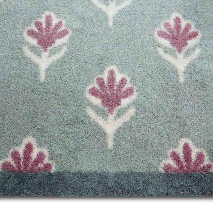 Disty Floral Green- Made from 100% recycled cotton featuring a woodblock pattern of purple flowers.