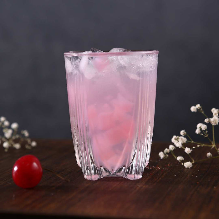 Mont Blanc glass filled with fresh juice on a breakfast table.